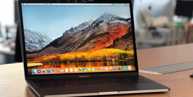 A MacBook Pro 2018 sitting on a desk in an office