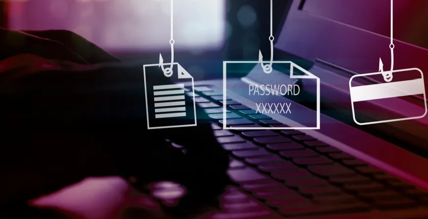Image depicting hands typing on a keyboard, with phishing hooks holding files, passwords and credit cards.