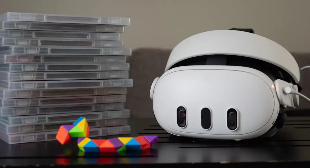 A Meta Quest 3 headset with a stack of game boxes next to it
