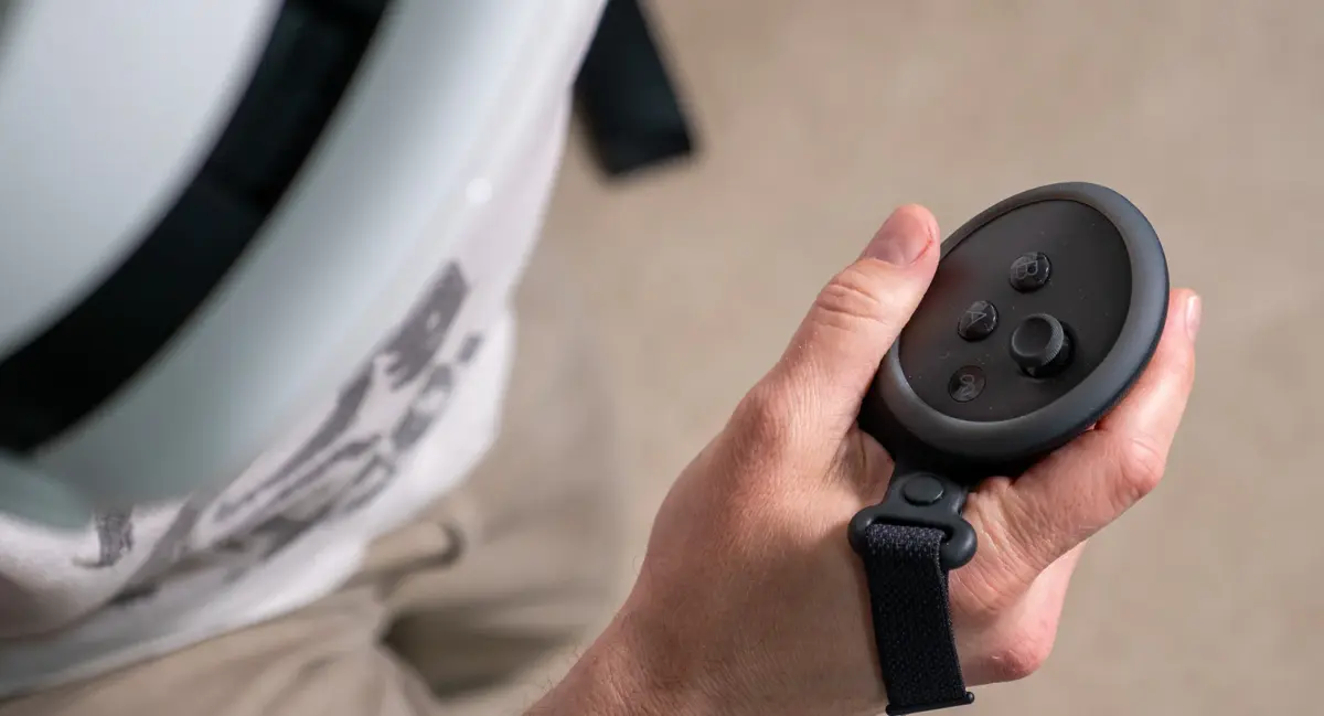 Holding a Meta Quest 3 controller while playing