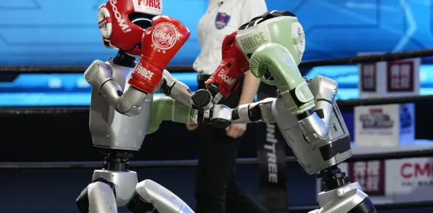 Robots boxing in a ring during a competition.