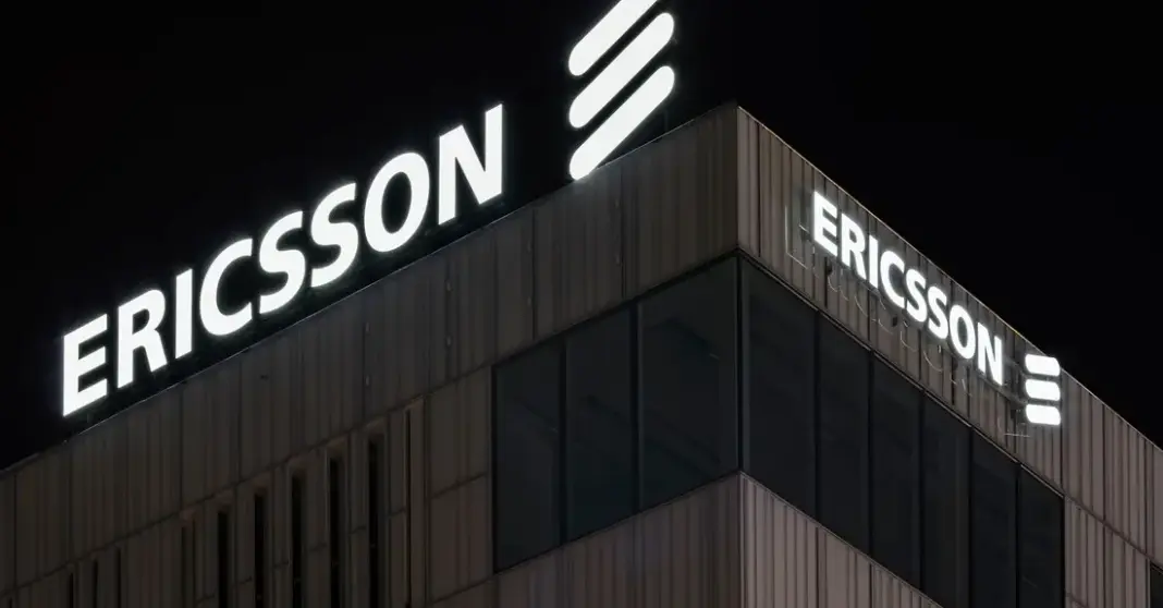 Gedung kantor Ericsson di malam hari dengan nama perusahaan menyala