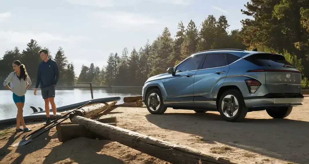 Hyundai Kona Electric 2025 parkir di tepi danau dengan dua orang