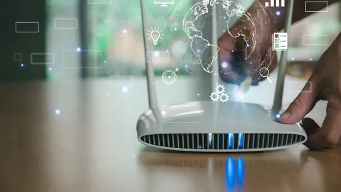 Selective focus at router. Internet router on working table with blurred man connect the cable at the background. Fast and high speed internet connection from fiber line with futuristic icon