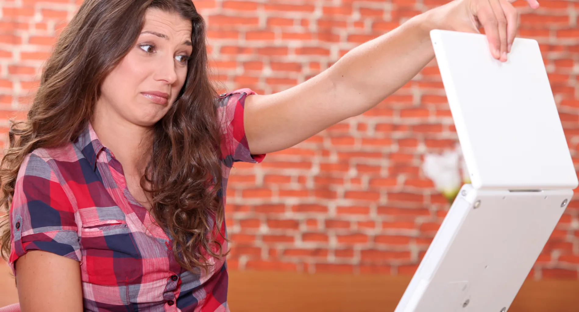 Woman disgusted by her laptop