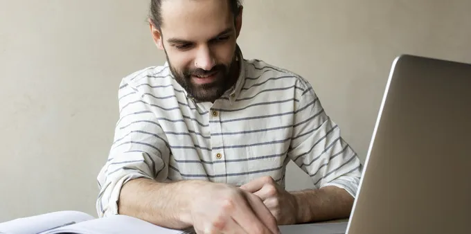 Man putting USB drive in laptop