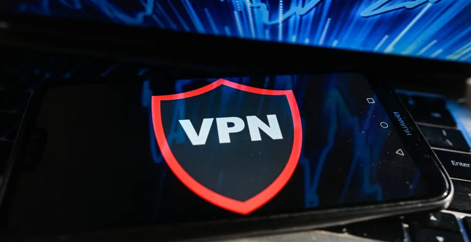 A VPN runs on a mobile phone placed on a laptop keyboard