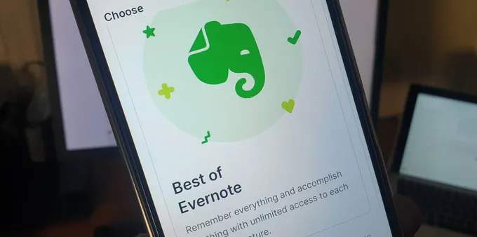 Person holding a phone with Evernote app open