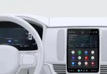Android Automotive Siapkan Fitur Kunci PIN untuk Aplikasi Pribadi Ilustrasi dashboard mobil modern dengan sistem infotainment Android Automotive yang menyala, menampilkan antarmuka Google.