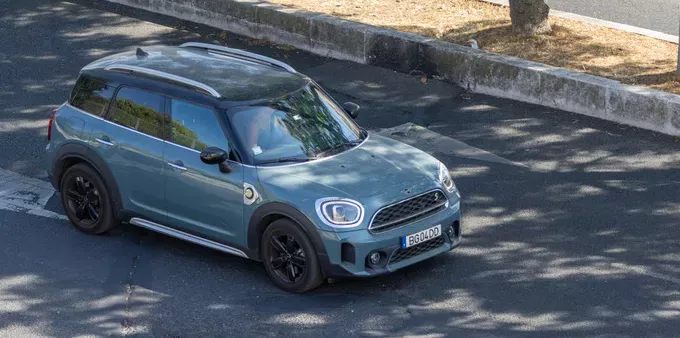 A blue-gray Mini Countryman in the street.